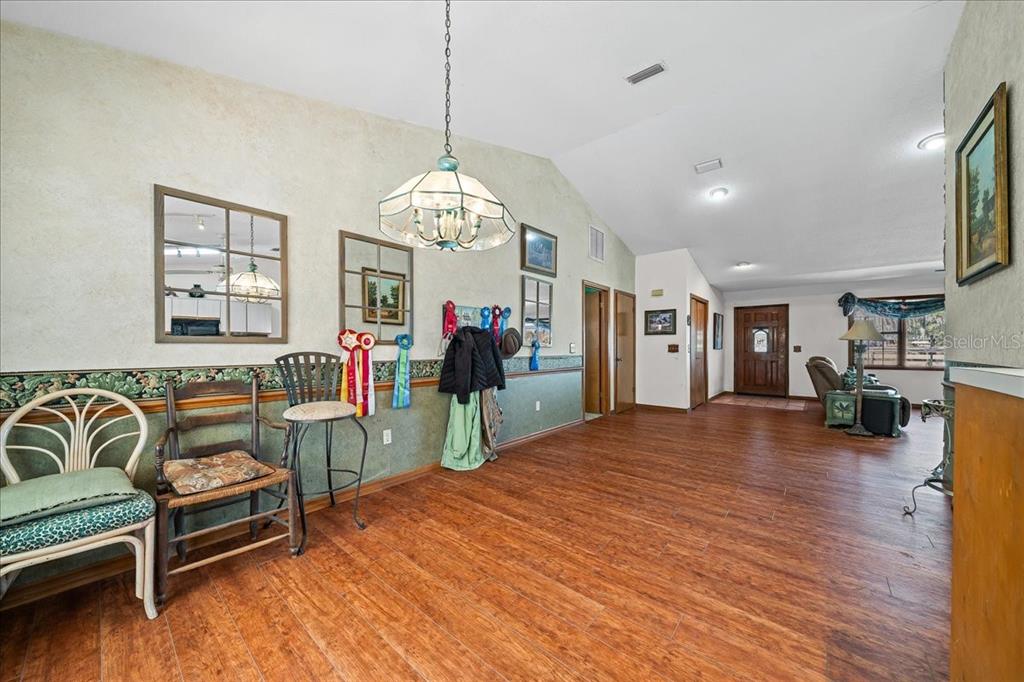 750 Southwest 91st Place Ocala, FL 34476 - Photo 19 of 51 a view of a livingroom with furniture chandelier and wooden floor