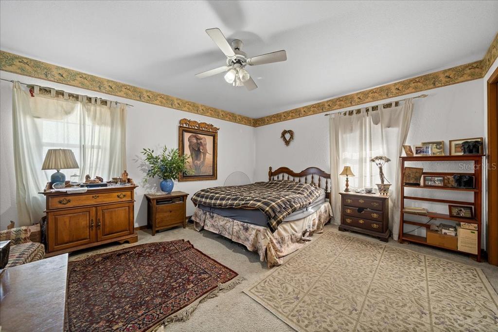 750 Southwest 91st Place Ocala, FL 34476 - Photo 23 of 51 a bedroom with a bed furniture and windows