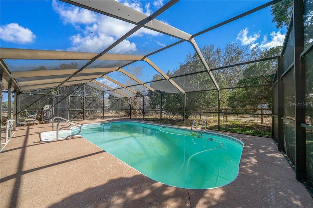 750 Southwest 91st Place Ocala, FL 34476 - Photo 29 of 51 a view of a swimming pool with a patio and a yard