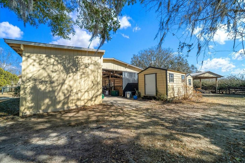 750 Southwest 91st Place Ocala, FL 34476 - Photo 37 of 51 a backyard of a house with large trees and outdoor seating