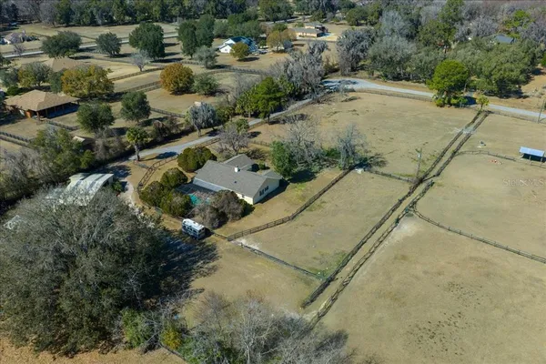 an aerial view of a house with a yard