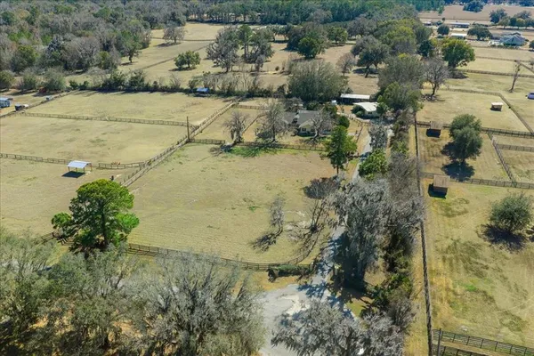 an aerial view of a residential houses with outdoor space