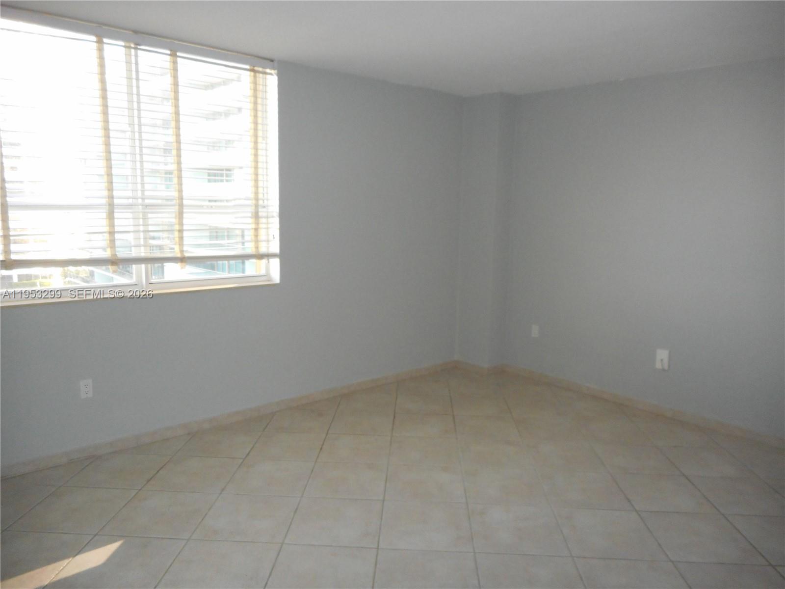10185 Collins Avenue, Unit 1002 Bal Harbour, FL 33154 - Photo 17 of 27 an empty room with a window