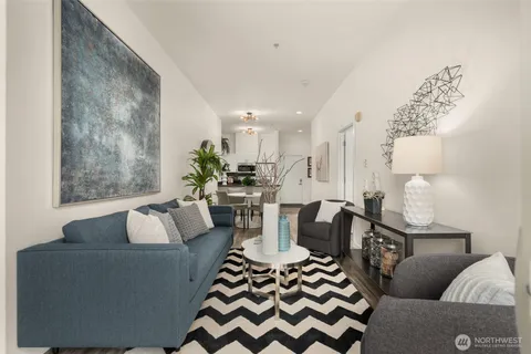a living room with furniture and a painting on the wall