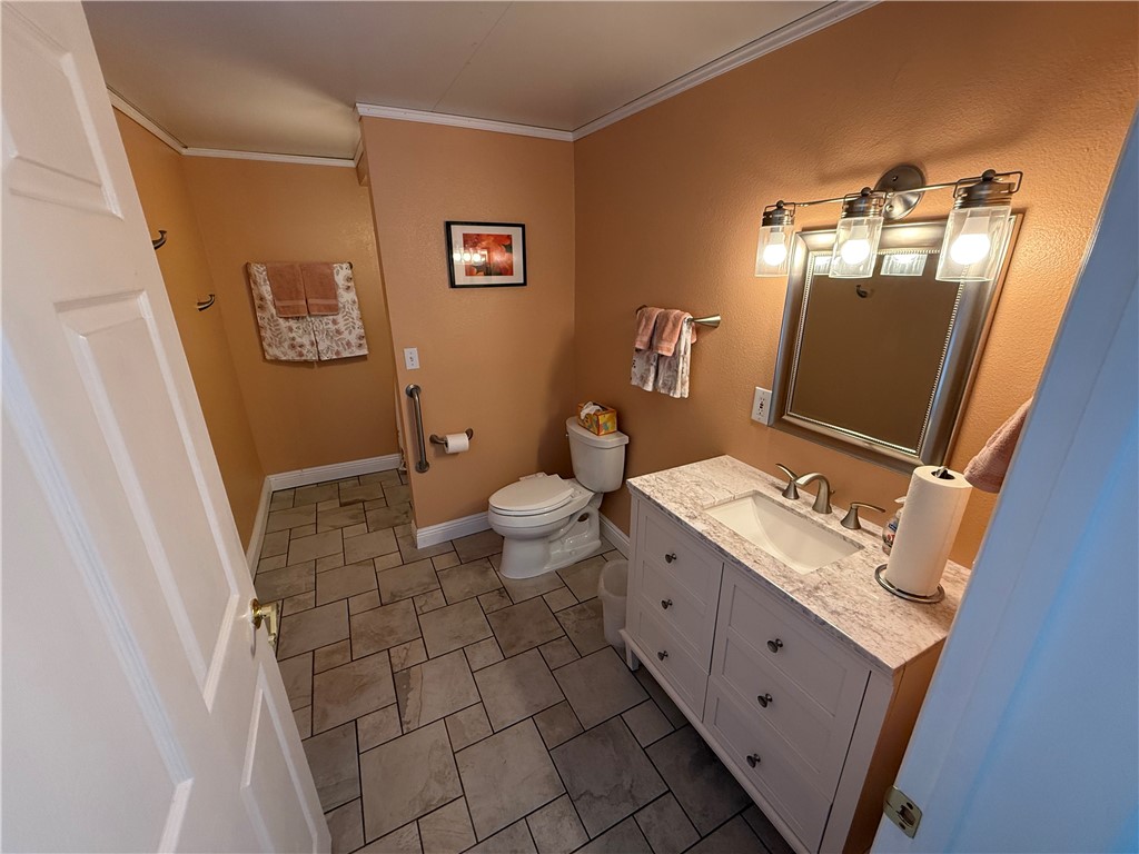 7262 Beryl Street Rancho Cucamonga, CA 91701 - Photo 25 of 30 a bathroom with a sink a toilet and a mirror