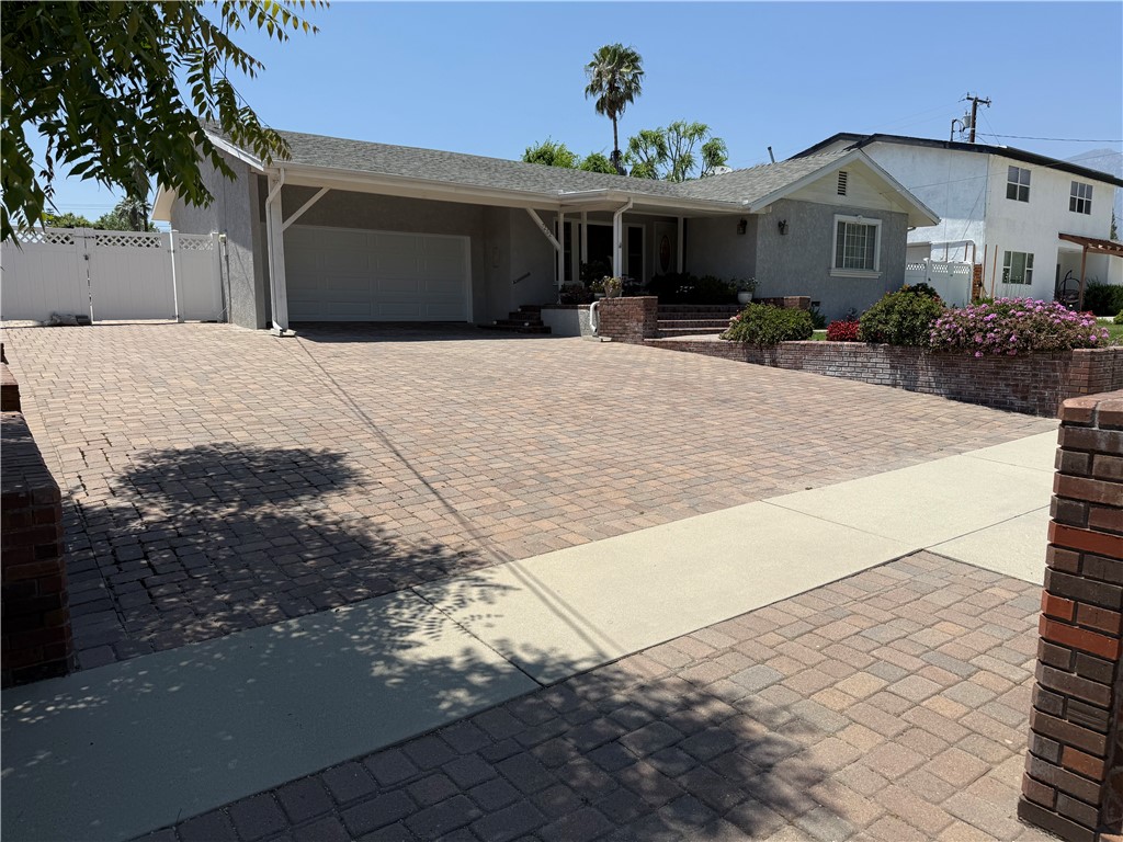 7262 Beryl Street Rancho Cucamonga, CA 91701 - Photo 4 of 30 a view of a house with potted plants in front of it