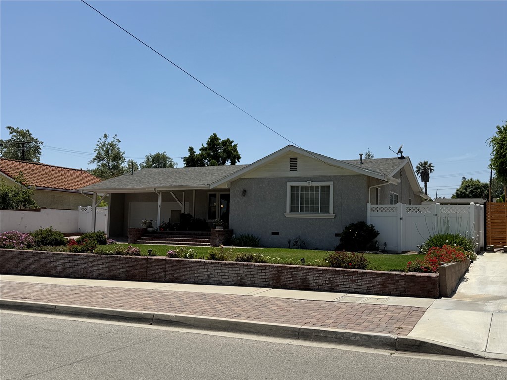 7262 Beryl Street Rancho Cucamonga, CA 91701 - Photo 7 of 30 a front view of a house with a yard and potted plants