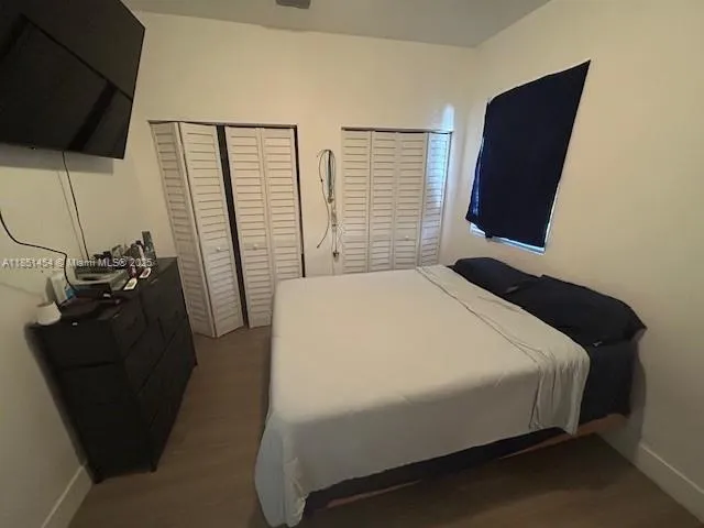a bedroom with a bed tv and view of the wall