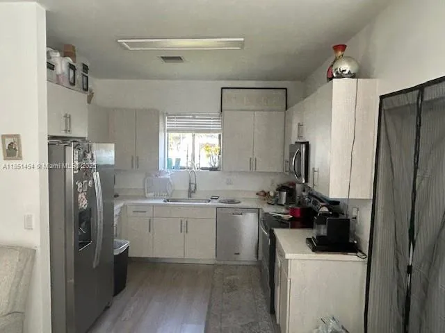 a kitchen with a sink and refrigerator