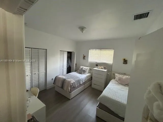 a bedroom with two beds and a window