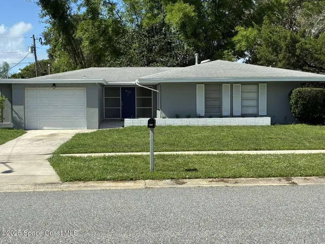 a view of a yard in front view of a house