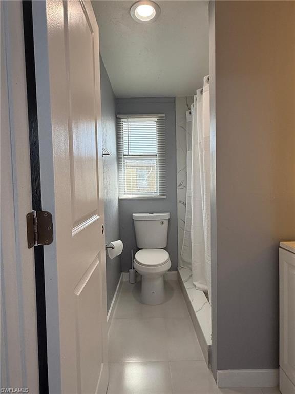 5317 Fleming Street Naples, FL 34113 - Photo 4 of 8 Bathroom with recessed ceiling lighting, a window featuring horizontal blinds, and a white toilet