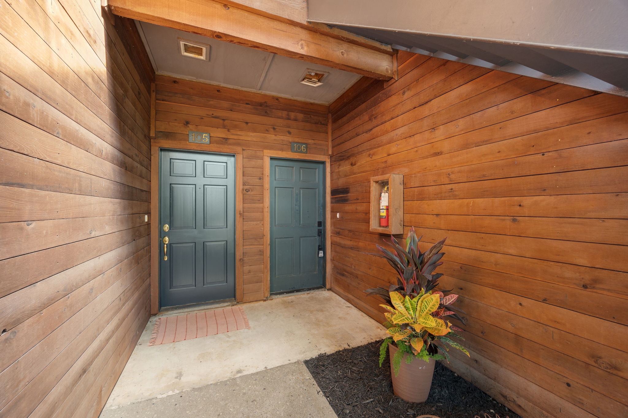 4711 Spicewood Springs Road, Unit 1106 Austin, TX 78759 - Photo 13 of 19 Wood-clad exterior with two paneled entry doors, concrete flooring, and recessed ceiling lighting