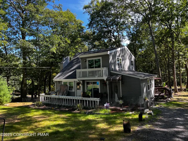 a view of a house with backyard porch and sitting area