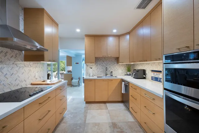 a kitchen with a sink stove and cabinets