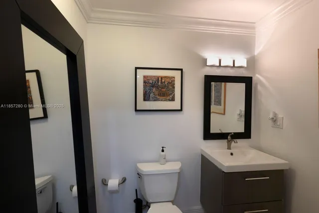 a bathroom with a toilet a sink and mirror