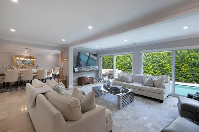 a living room with furniture large window and a fireplace