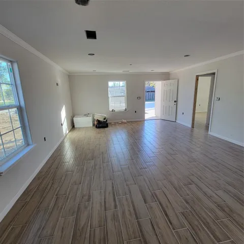 a view of a room with wooden floor and window
