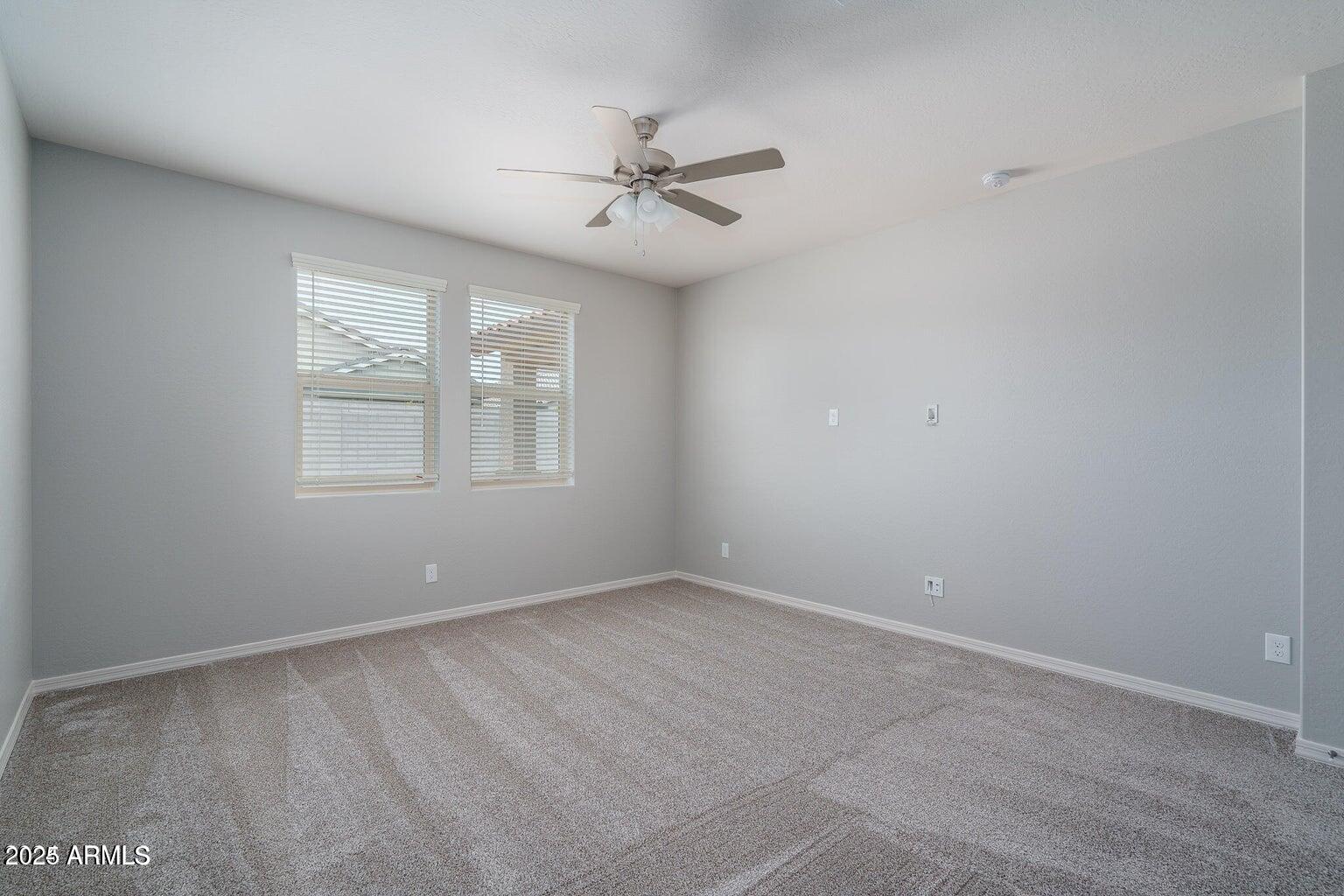 16172 West Alameda Road Surprise, AZ 85387 - Photo 11 of 53 an empty room with windows and fan