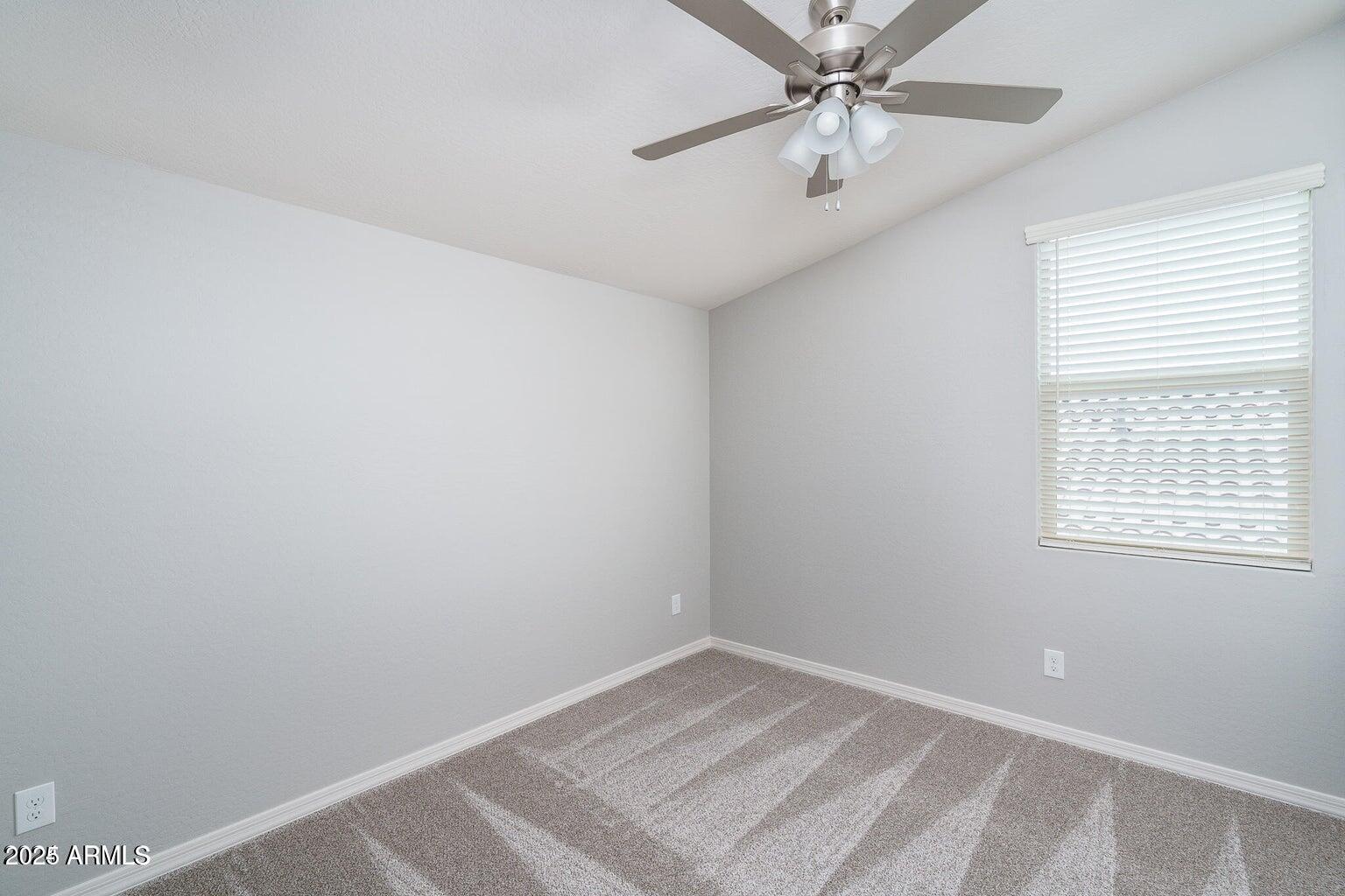 16172 West Alameda Road Surprise, AZ 85387 - Photo 20 of 53 an empty room with a window and a fan