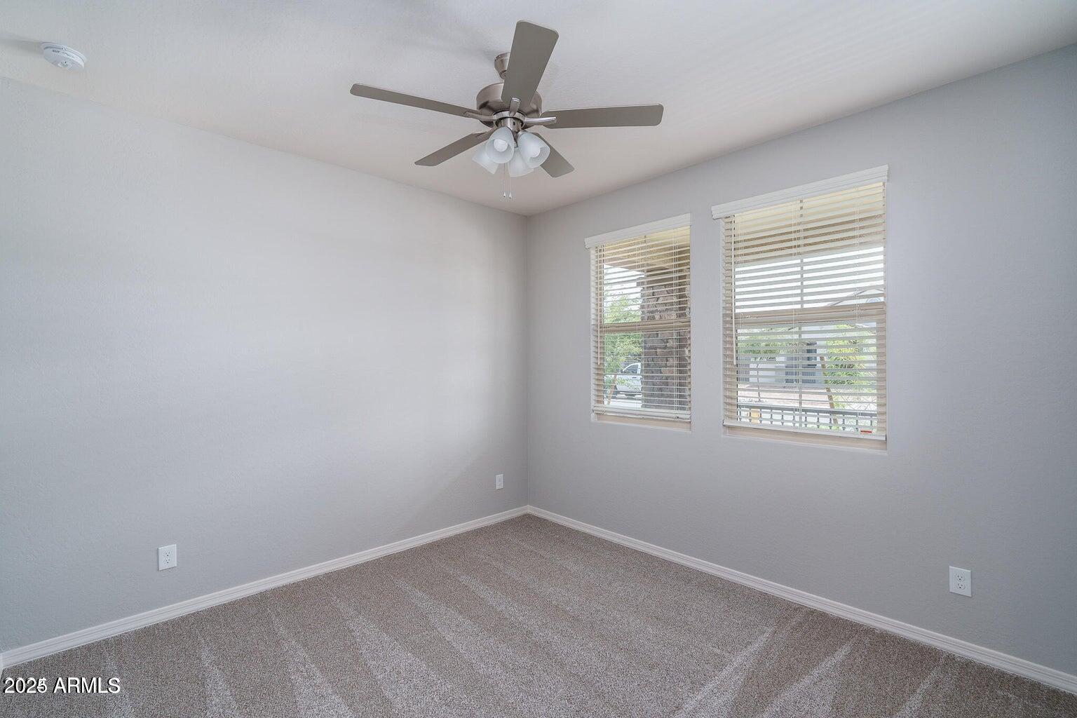 16172 West Alameda Road Surprise, AZ 85387 - Photo 23 of 53 an empty room with a window and a fan
