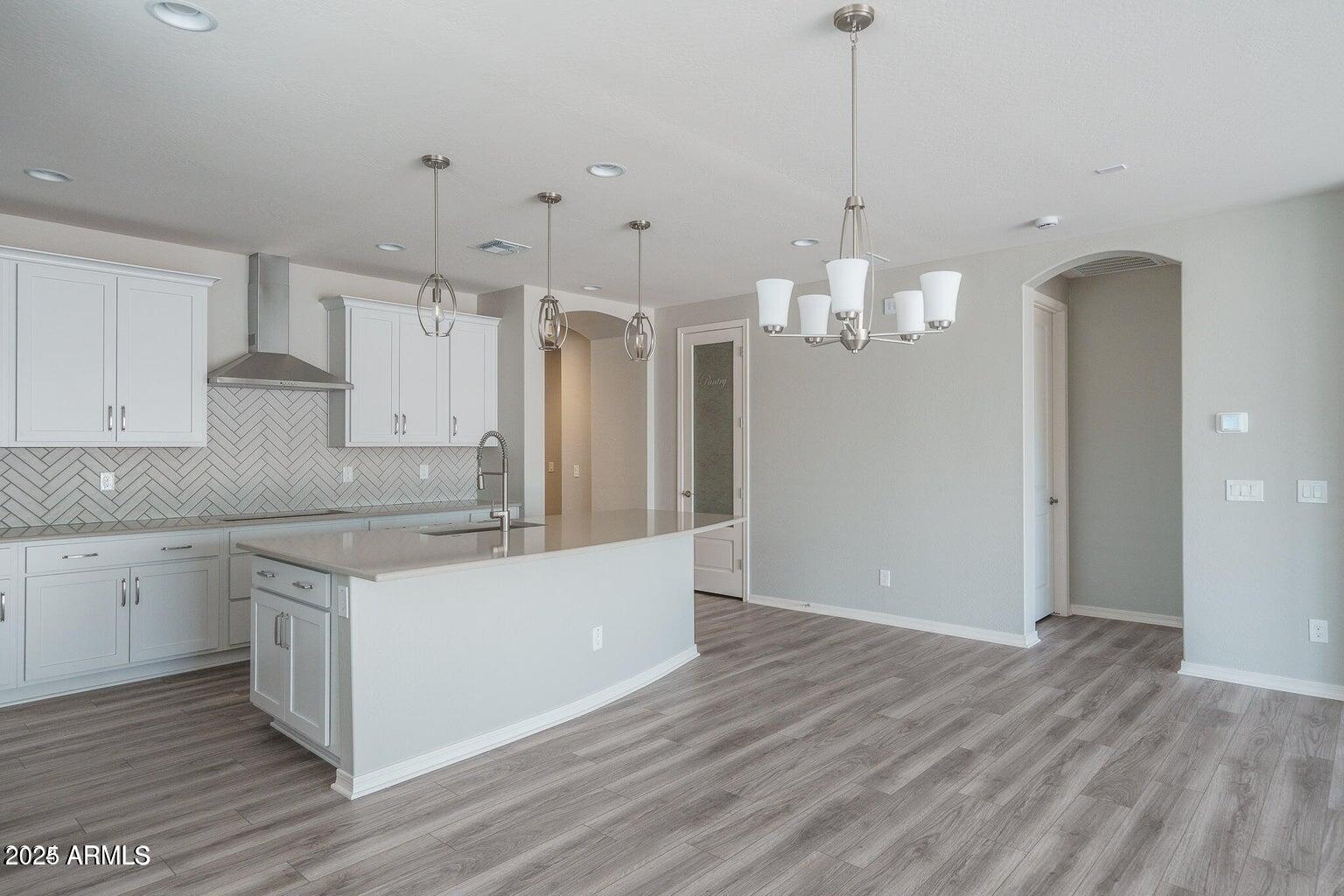 16172 West Alameda Road Surprise, AZ 85387 - Photo 6 of 53 a kitchen that has a lot of cabinets and wooden floor