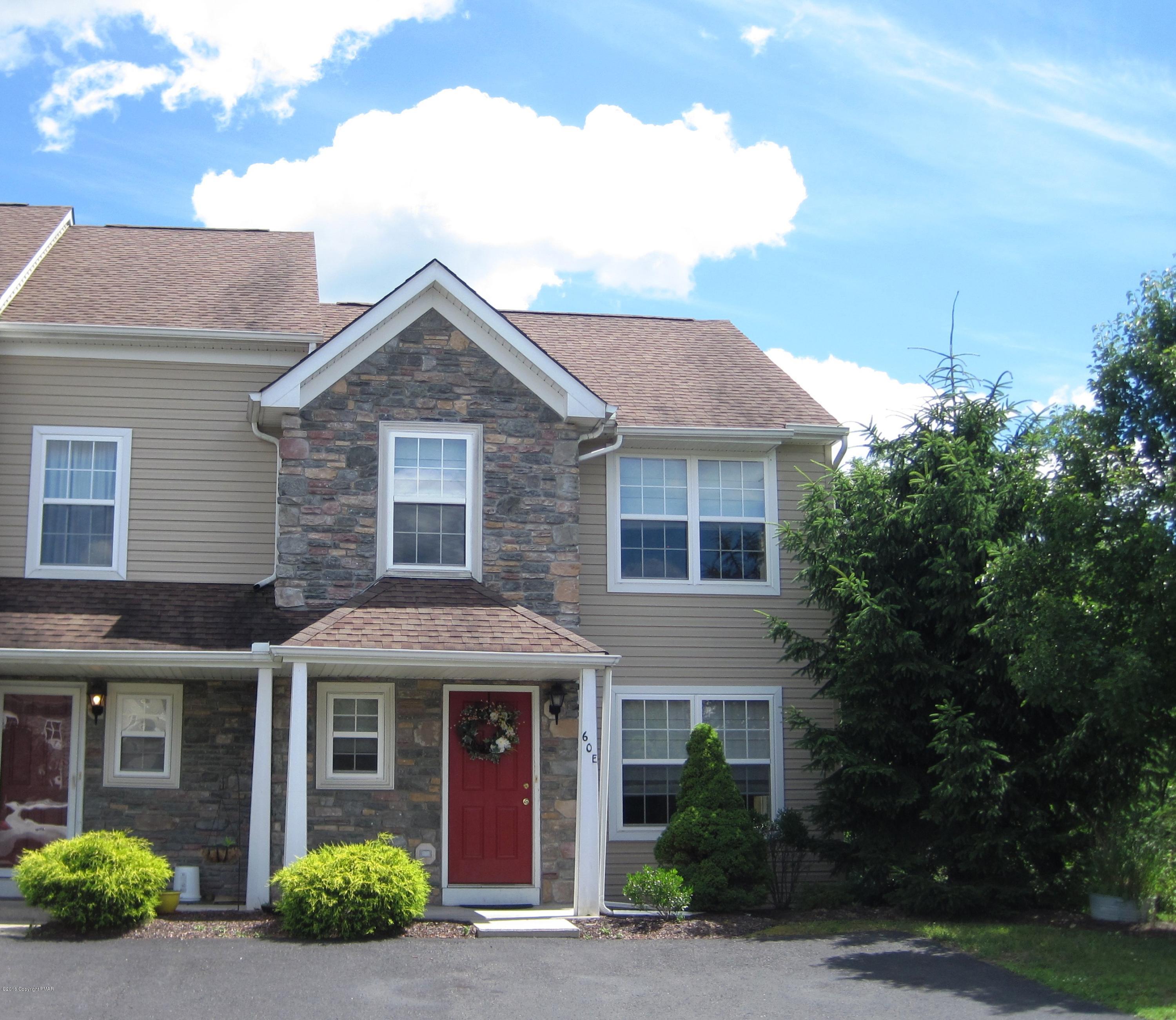 a front view of a house with yard and green space