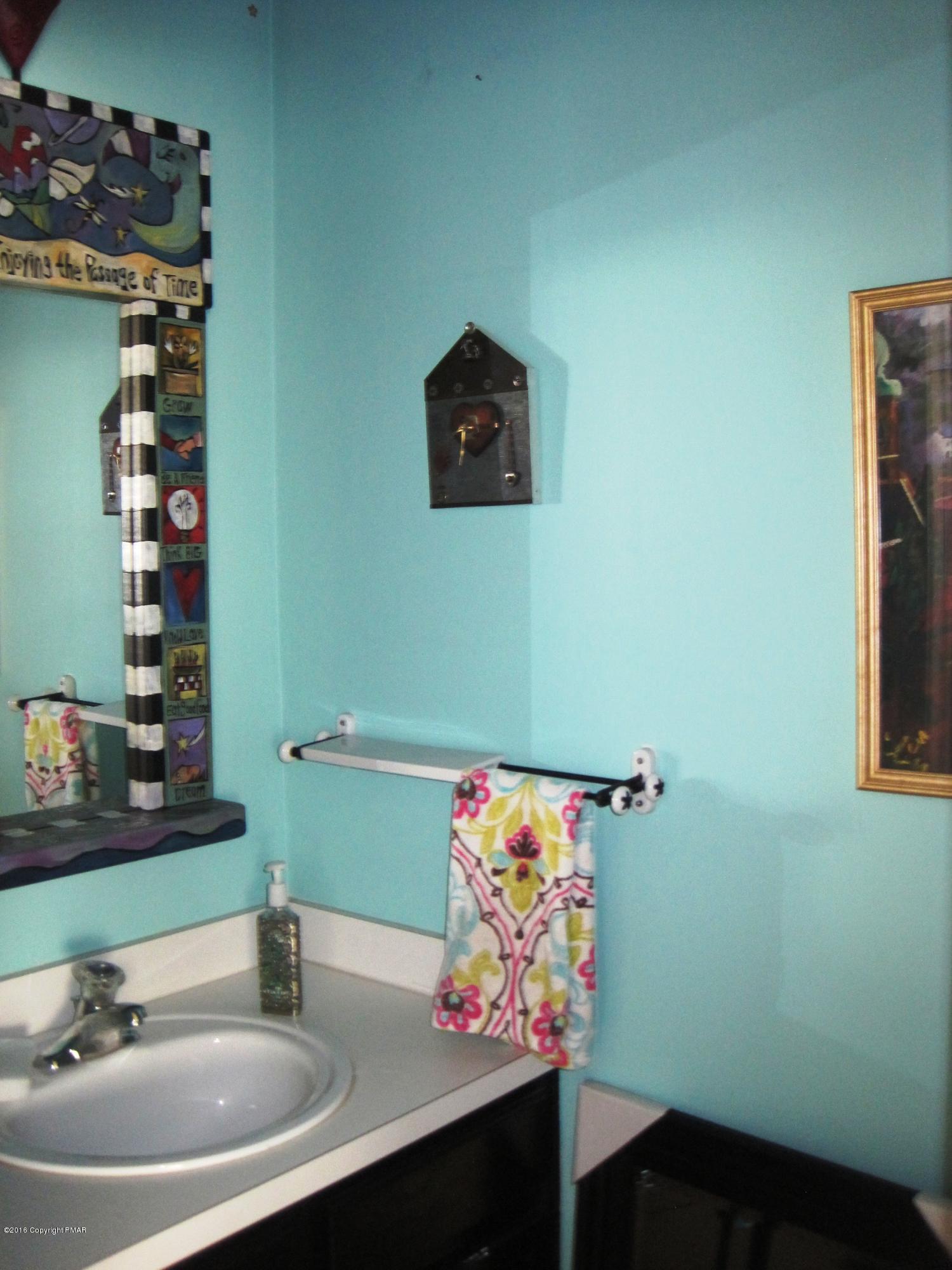 60 Lower Ridgeview Circle East Stroudsburg, PA 18302 - Photo 11 of 12 a bathroom with a sink mirror and vanity