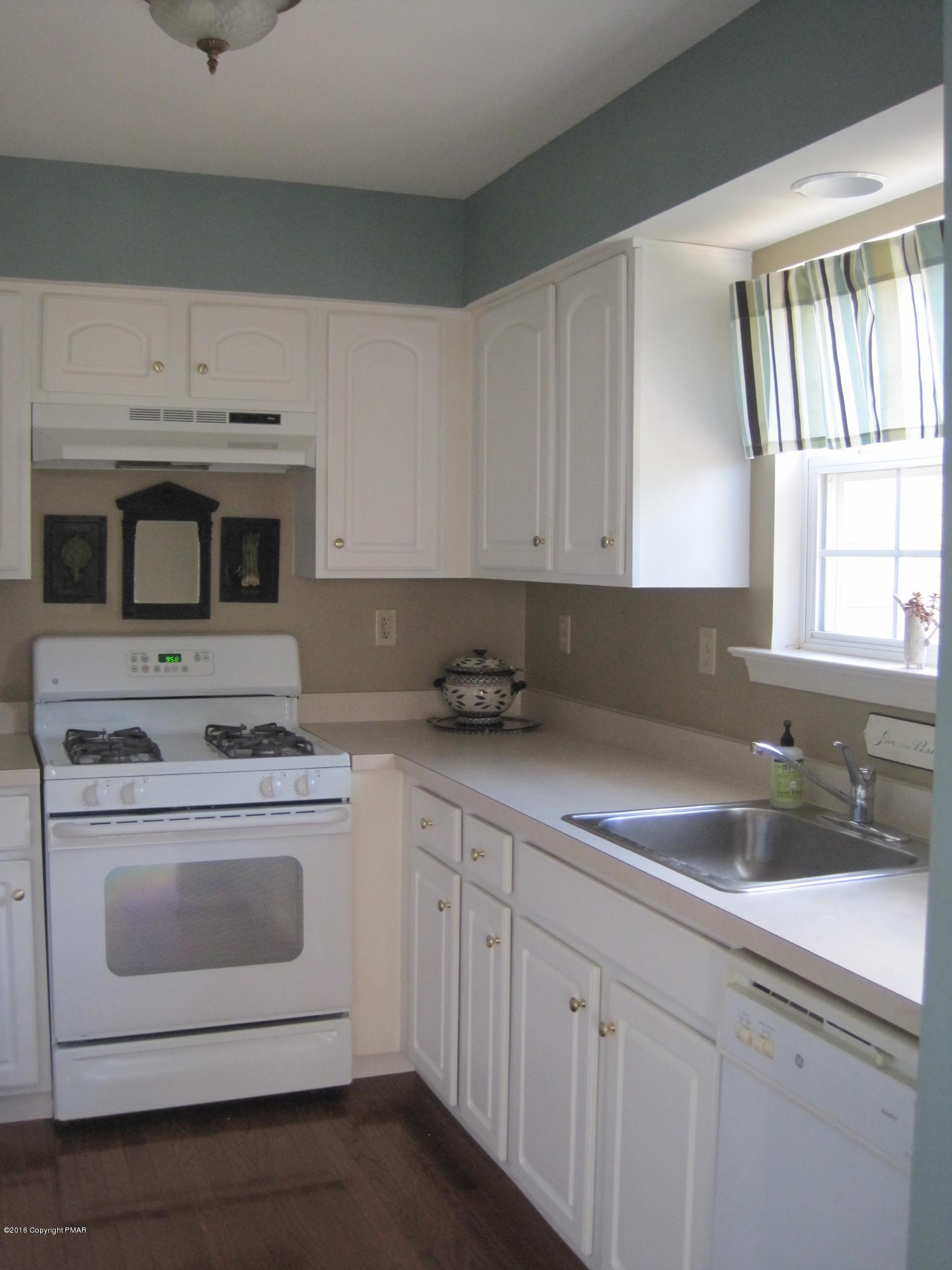 60 Lower Ridgeview Circle East Stroudsburg, PA 18302 - Photo 2 of 12 a kitchen with white cabinets stainless steel appliances and sink