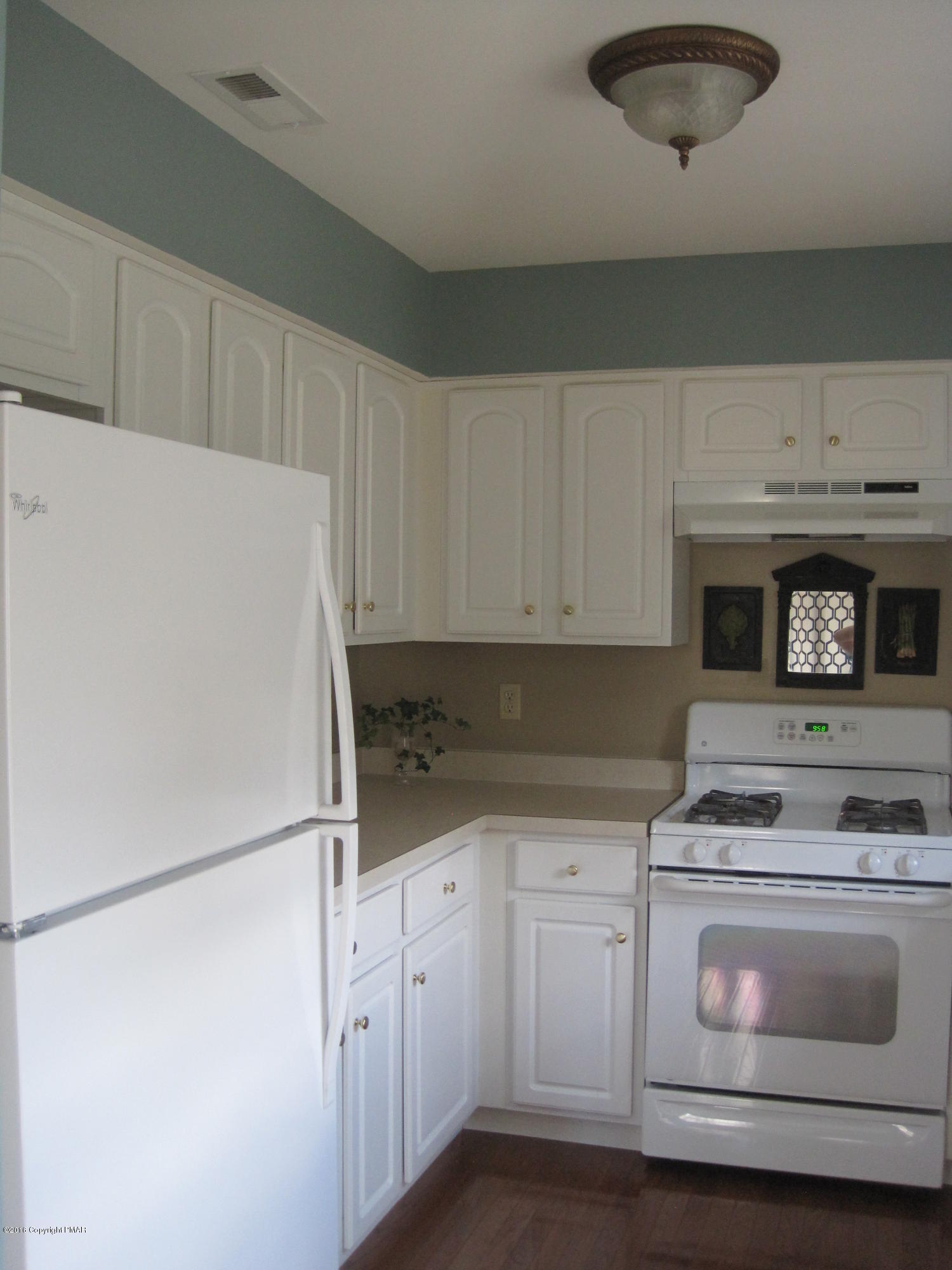 60 Lower Ridgeview Circle East Stroudsburg, PA 18302 - Photo 3 of 12 a kitchen with granite countertop white cabinets and white appliances