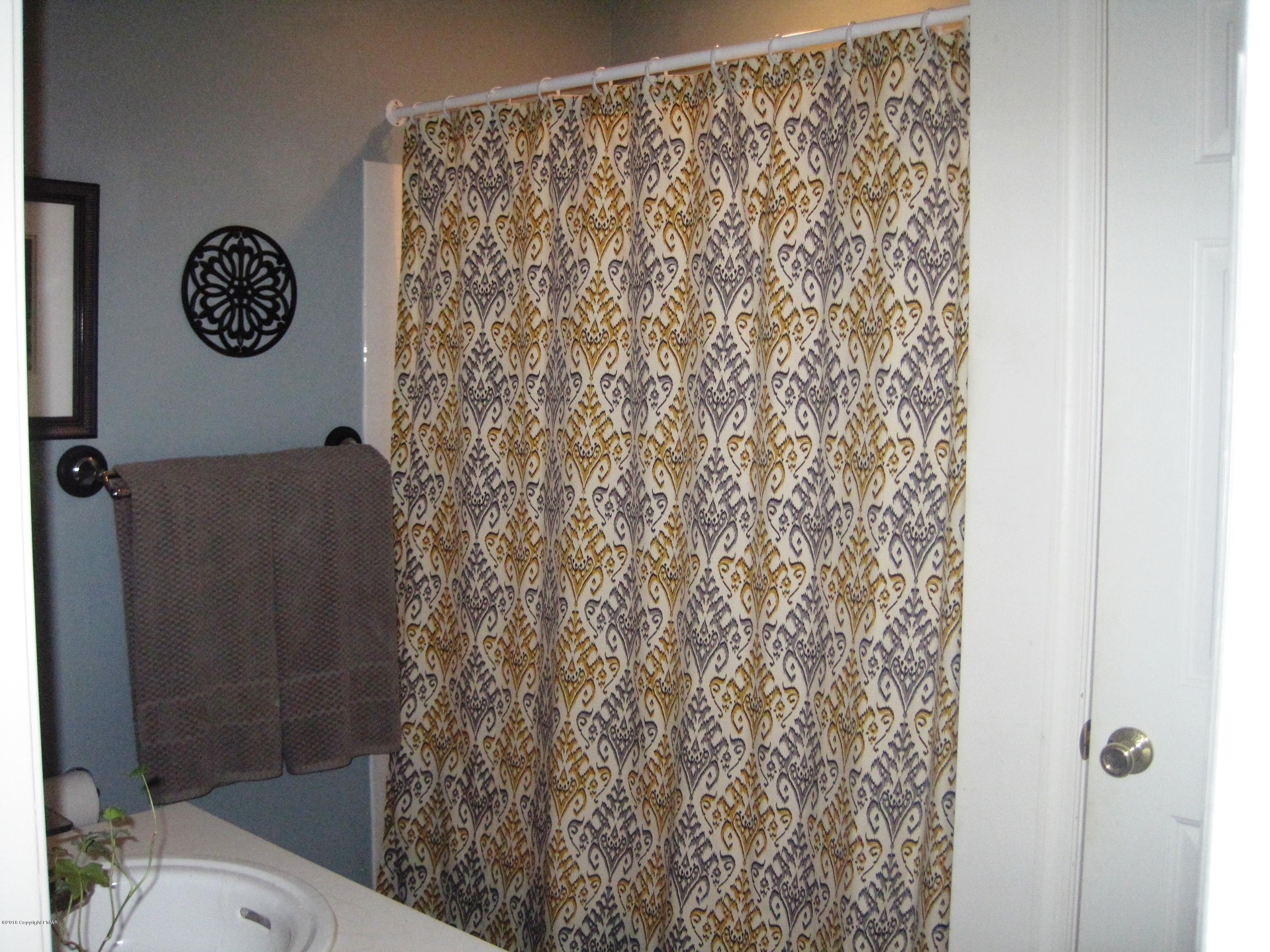 60 Lower Ridgeview Circle East Stroudsburg, PA 18302 - Photo 10 of 12 a bathroom with a toilet and a shower curtain