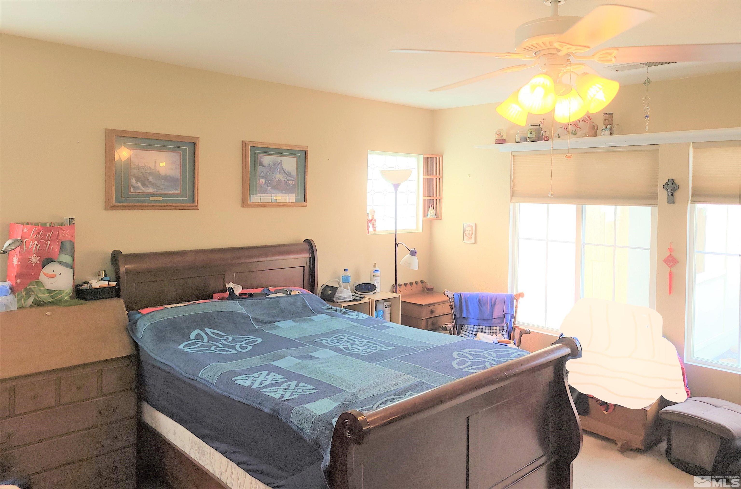 7665 Bichon Street Reno, NV 89506 - Photo 4 of 15 a bedroom with a bed and a dresser