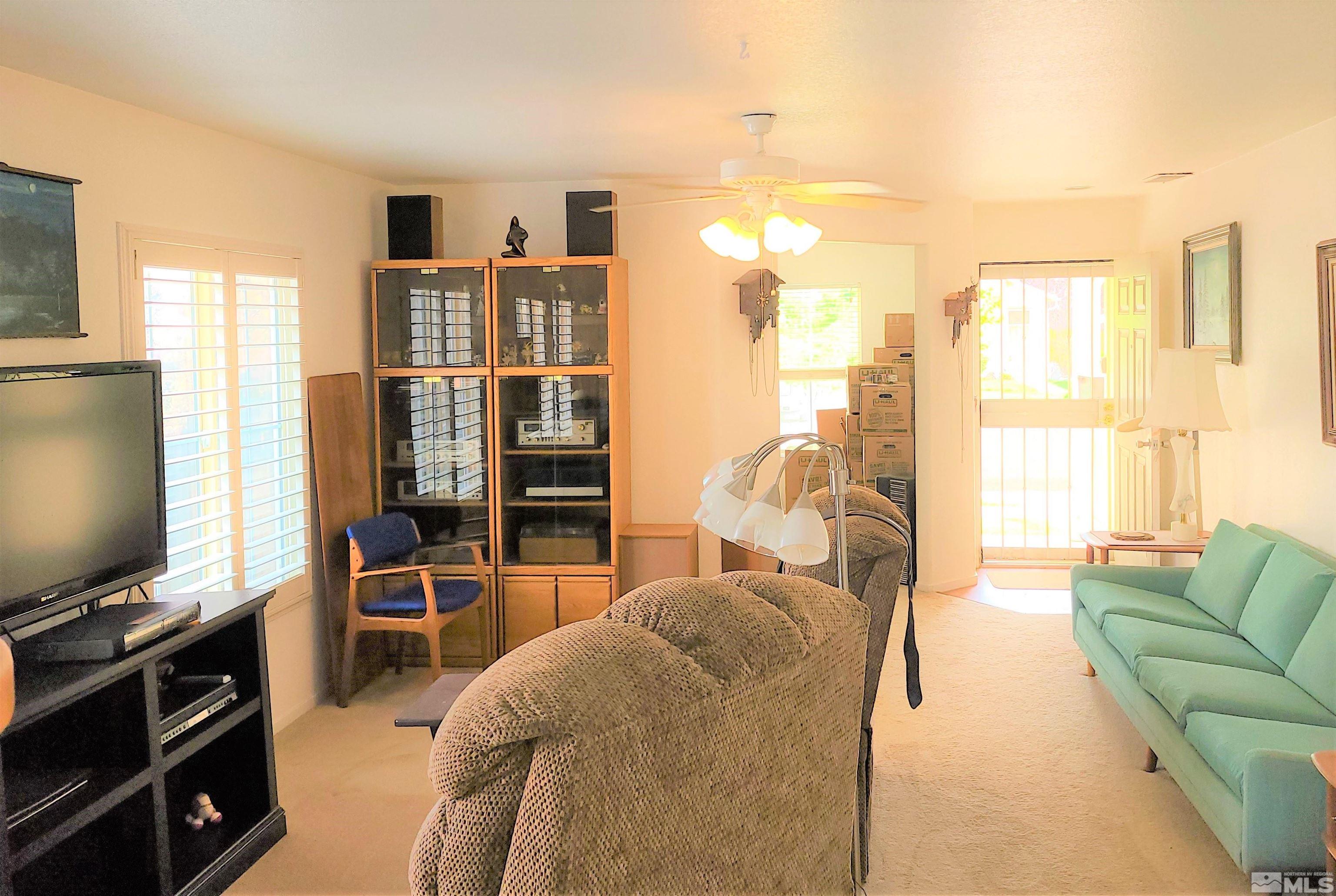 7665 Bichon Street Reno, NV 89506 - Photo 8 of 15 a living room with furniture and a flat screen tv
