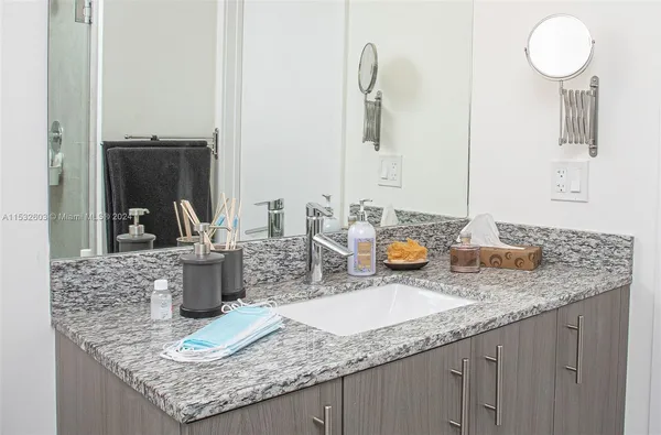 a bathroom with sinks granite countertop a sink and a mirror