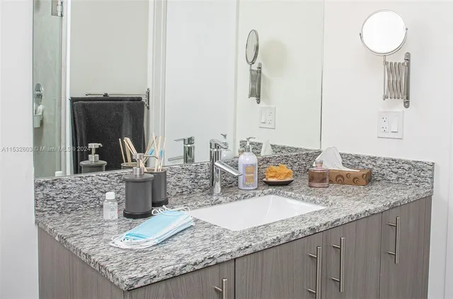 a bathroom with sinks granite countertop a sink and a mirror