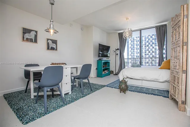 a bedroom with a bed a chair and a window