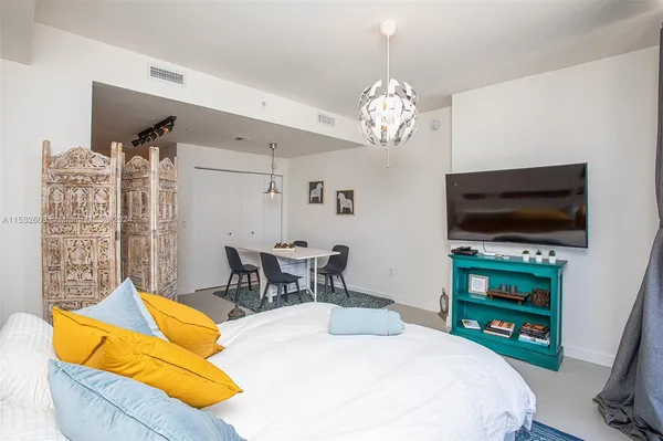 a bedroom with a bed and a flat screen tv