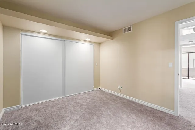a bathroom with a granite countertop sink a toilet and shower