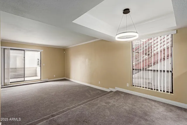an empty room with sliding glass door and shower