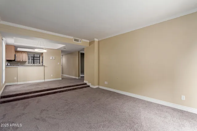 a view of a hallway with wooden floor and windows