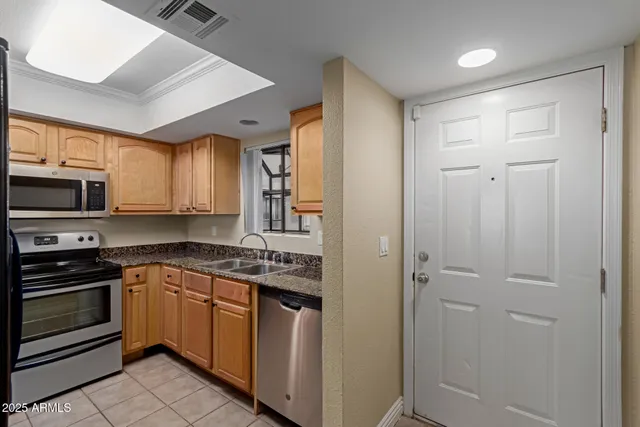 a kitchen with a sink stove and microwave
