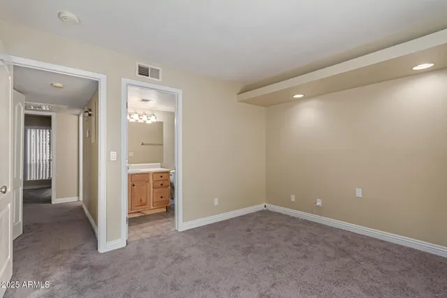 an empty room with closet and a bathroom