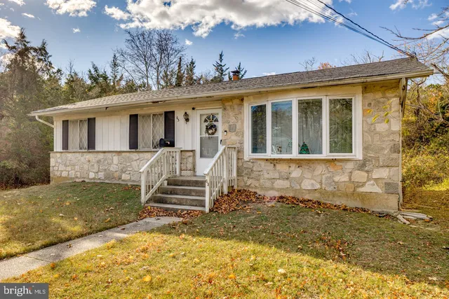 a view of a house with a yard patio and fire pit