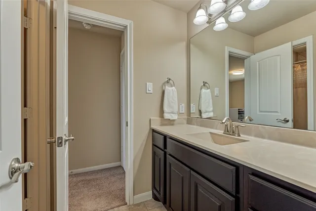 a bathroom with a double vanity sink and a mirror