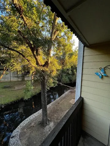 a view of a wooden floor and a tree