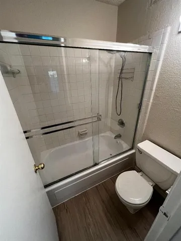 a bathroom with a toilet and a shower
