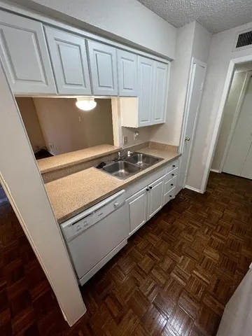 a kitchen with granite countertop a stove and a refrigerator