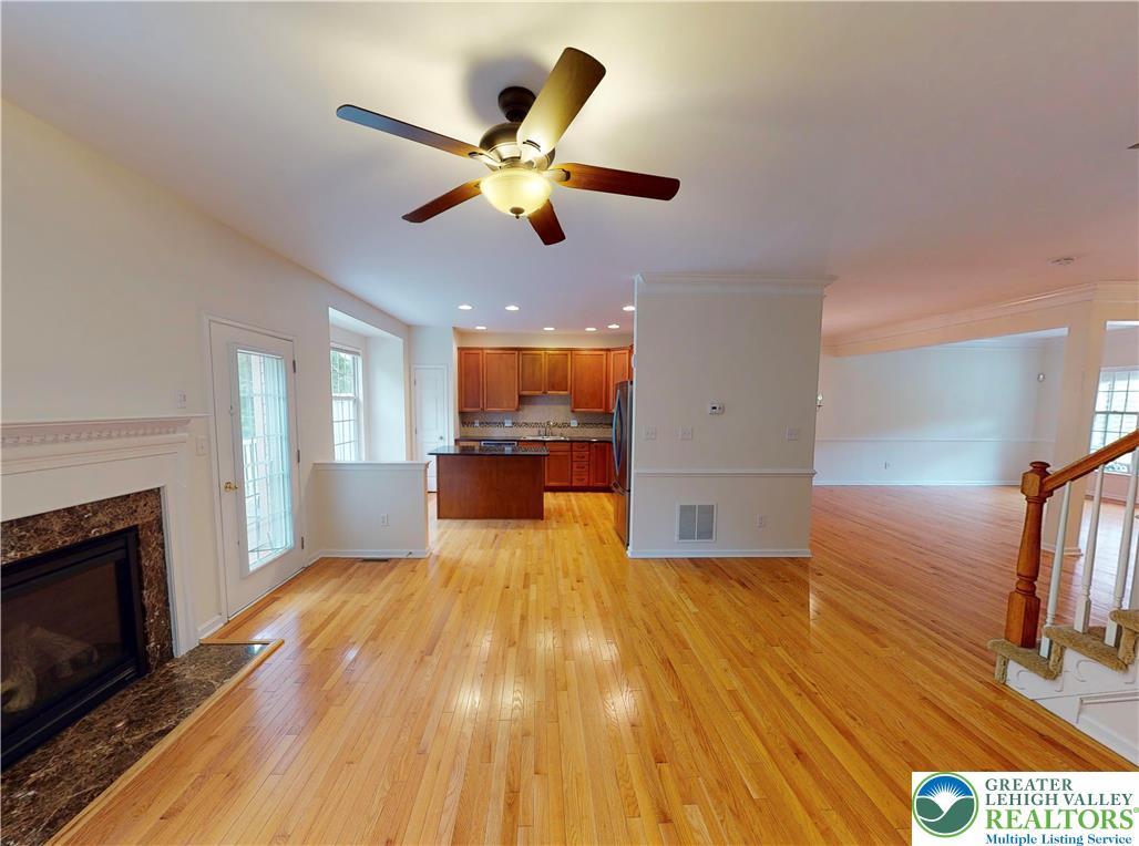 1824 Big Ridge Drive East Stroudsburg, PA 18302 - Photo 13 of 46 a view of a livingroom with a fireplace a ceiling fan and wooden floor