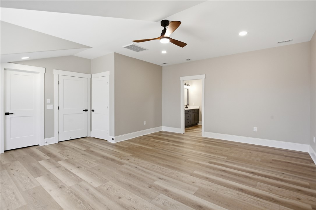 147 McAlister Road West Union, SC 29696 - Photo 33 of 49 This spacious upstairs bedroom features durable flooring, offering both comfort and easy access to the adjacent bathroom.