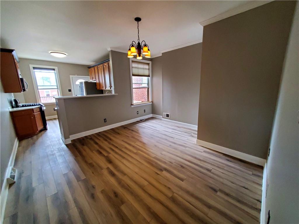 905 Deely Street Pittsburgh, PA 15217 - Photo 9 of 19 a bedroom with wooden floor and windows